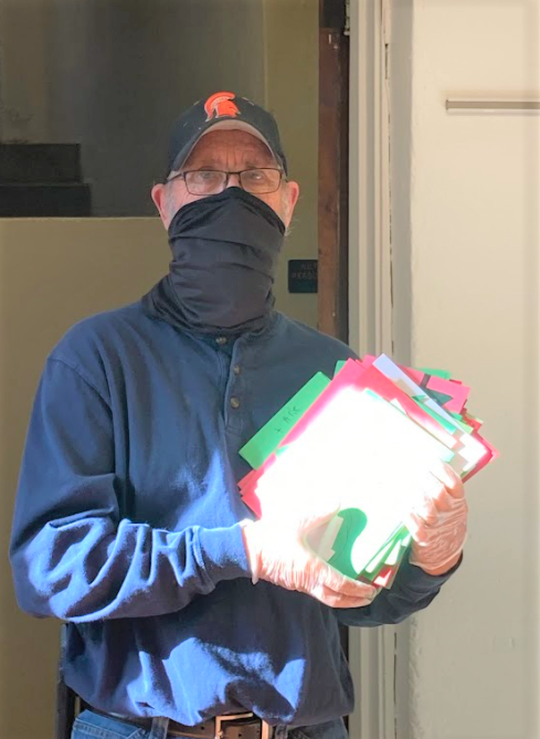 man holding a stack of papers